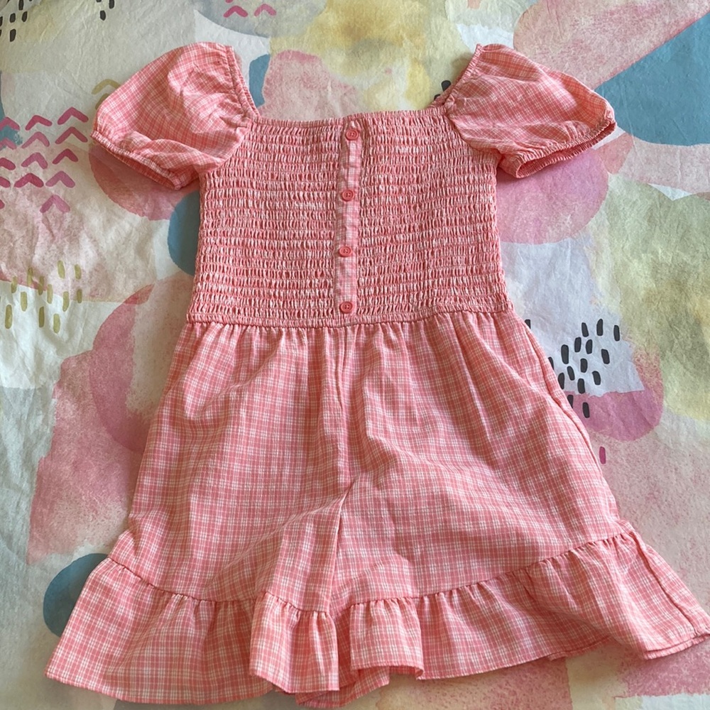 Selling girls pink plaid rompers from art class
